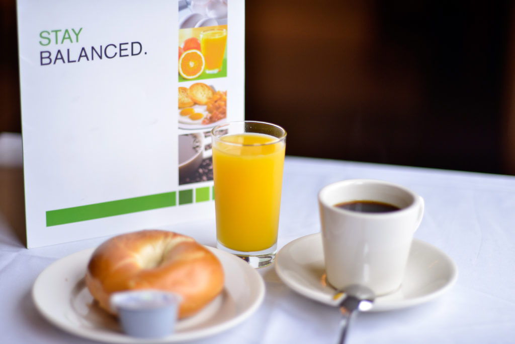 Holiday Inn New York JFK Airport Area menu, bagel, orange juice, and coffee