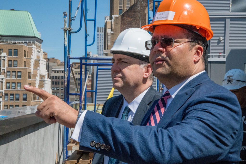 Executives inspect a hotel construction site